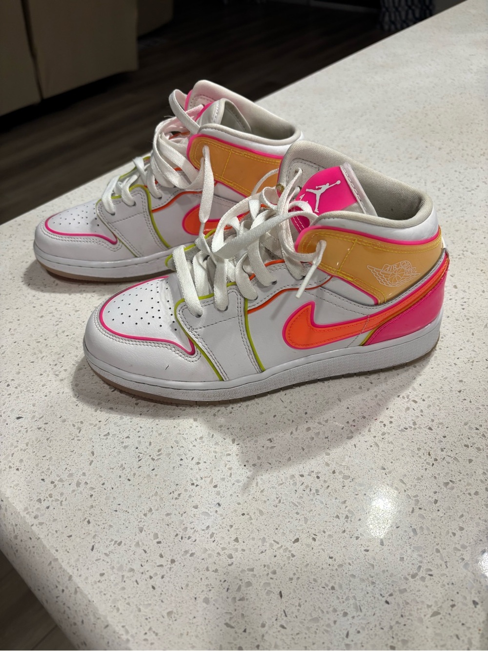 Jordan white sneakers with neon pink and orange accents